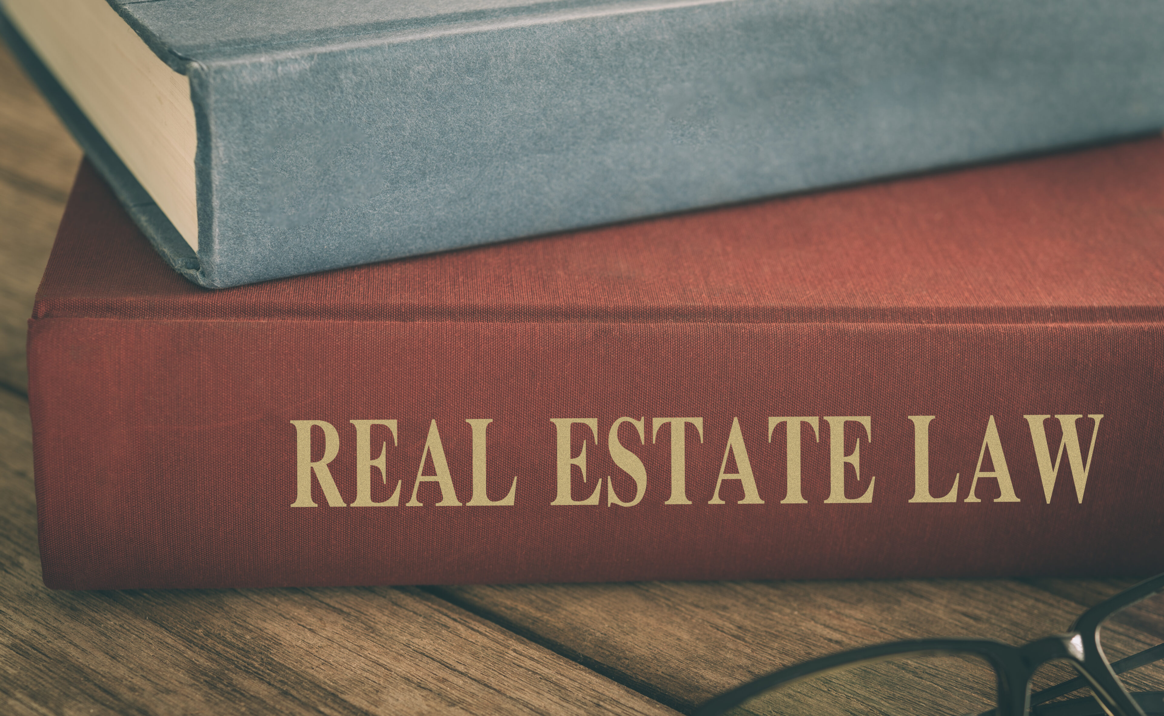 Real estate law book on wooden table.