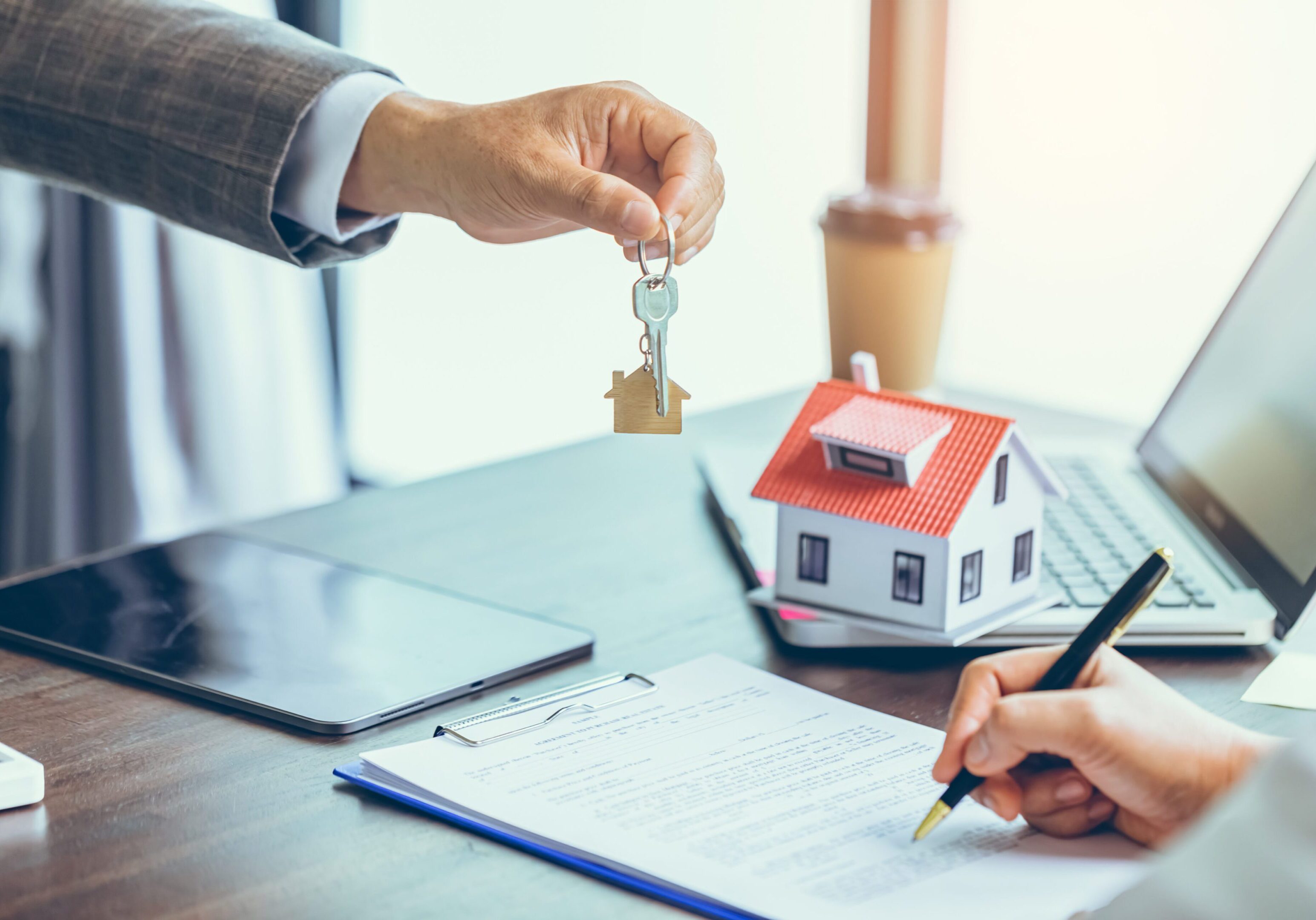 Real estate transaction with house keys.